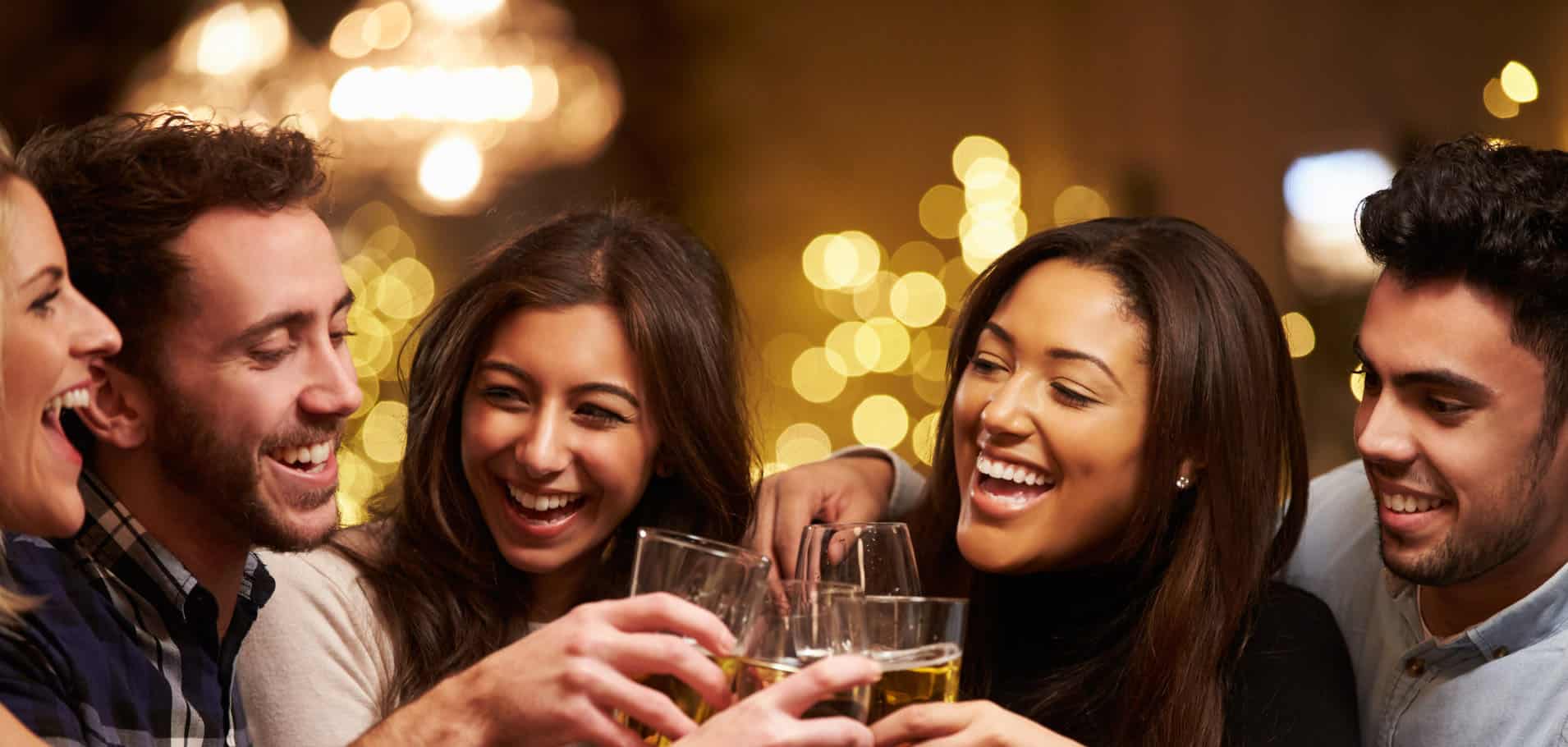 Group Of Friends Enjoying Evening Drinks In Bar